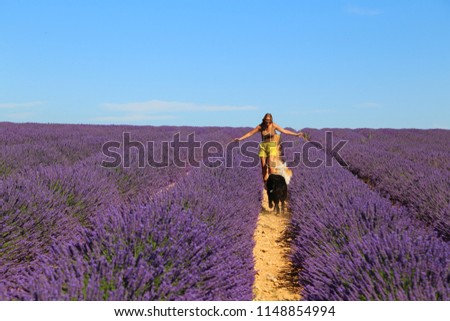Young woman with dog in the lavander field