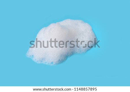 Soap bubbles foam on blue white background