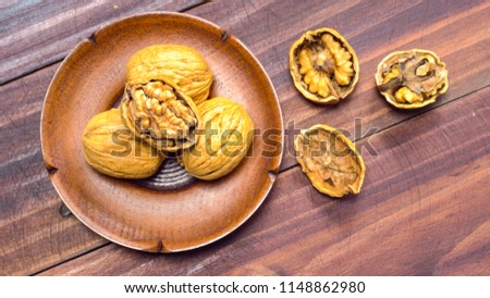 Walnuts on dark vintage table, Walnuts kernels in wooden bowl. Walnut healthy food