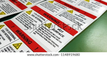 Danger sign banner with warning text,"HOT SURFACE" warning label in electronic industry