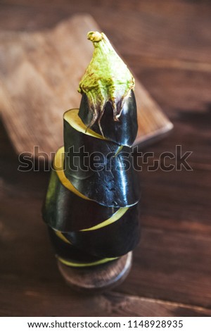 Natural texture of aubergine in a close-up section, side view. Toned picture of aubergine. Place and background for text