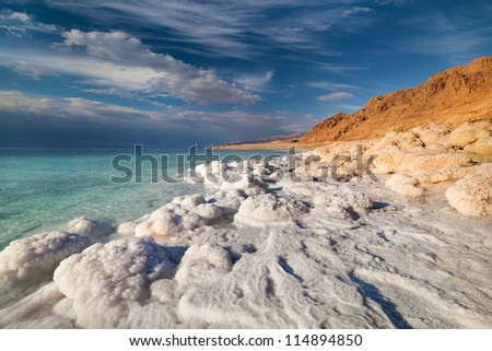 View of Dead Sea coastline at sunset time Royalty-Free Stock Photo #114894850