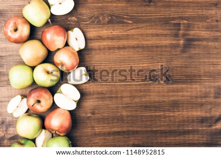 Sweet juicy red and green apples on wooden background. Free copy space for text. Top view, flat lay