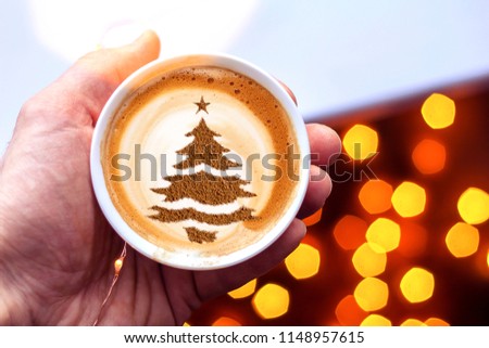 cup of Christmas cappuccino coffee with a Christmas tree pattern