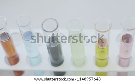 Test Tubes In Rack Filled With Pastel Coloured Liquids