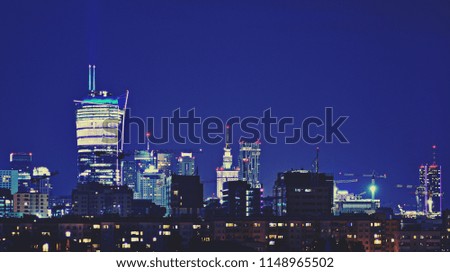 Fantastic view of a big city at night with illuminated modern architecture. Retro color stylized