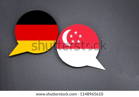 Germany and Singapore flags with two speech bubbles on dark gray background