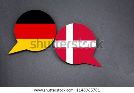 Germany and Denmark flags with two speech bubbles on dark gray background