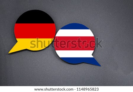 Germany and Costa Rica flags with two speech bubbles on dark gray background