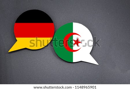Germany and Algeria flags with two speech bubbles on dark gray background
