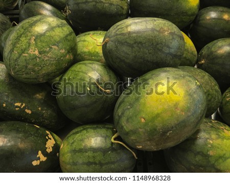 A pile of watermelons for sale in th market