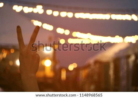 Blurred light night with two fingered, defocus, bokeh,night market concept,beautiful circle glitter merry Christmas and happy new year card celebrating lamp dark sky festival dusk blurry flare reflect