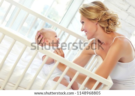 Mom and baby 2 months in baby bed
