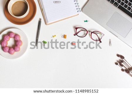 Flat lay workspace picture, cup of coffee, donut , notebook and pen on white background. Business workplace concept. Work desktop with coffee, enjoy working.