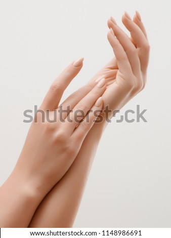 Closeup image of beautiful woman's hands with light pink manicure on the nails. Skin care for hands, manicure and beauty treatment. Elegant and graceful hands with slender graceful fingers Royalty-Free Stock Photo #1148986691