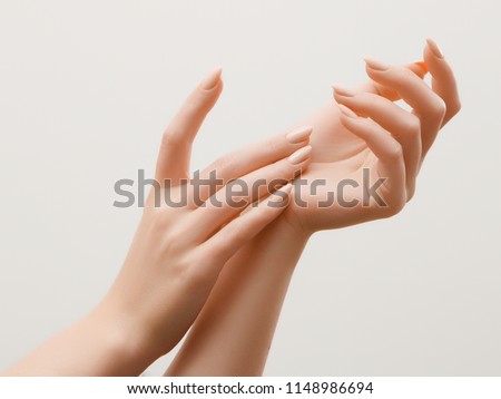 Closeup image of beautiful woman's hands with light pink manicure on the nails. Skin care for hands, manicure and beauty treatment. Elegant and graceful hands with slender graceful fingers Royalty-Free Stock Photo #1148986694