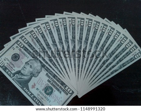 Arranged 10 usd dollars banknote isolated on black background.