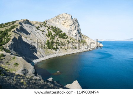 Beautiful rock off the coast of the sea. Turquoise water, blue sky, incredible landscape.