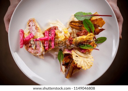 grilled cod fish served with artichoke and marinated beetroots
