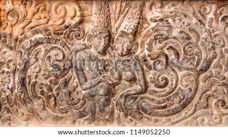 Example of indian artworks from near 7th century, man touching chest of the young woman on a bas-relief inside Hindu temple in Karnataka, India.