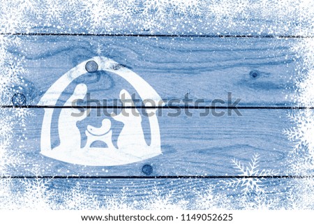 Nativity scene silhouette on blue wooden background