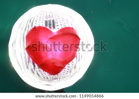 Transparency​ pink​ heart​ on​ glass​ cup​ made​ by​ dragon​ fruit​ skin