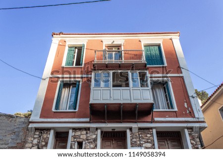 Bottom shot of perspective multi storey building orange colored facade at Lesvos in central part of region. Photo has taken in Greece.