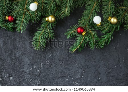 Christmas fir tree on black concrete background with copy space
