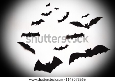 Flying bats over a white background with vignette effect giving sense of halloween.