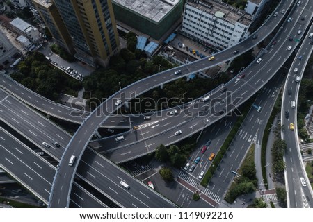 Aerial view of highway and overpass in city on sunny day