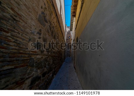 narrow streets of the Spanish city of Toledo, a medieval city with cobblestone and mud streets