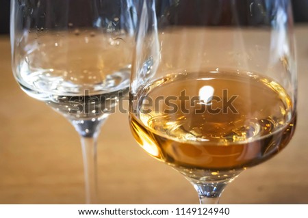 Two wine glasses with two different kinds of Bulgarian rakia alcoholic fruit brandy. 