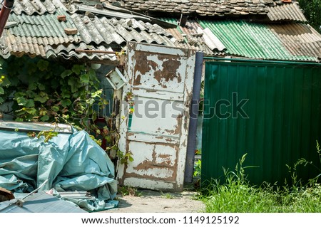 Improvised gate doors and house of refugee or homeless people in the ghetto of the city