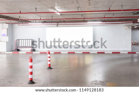 parking garage underground interior with blank billboard.Empty space car park interior at afternoon.Indoor parking lot.interior of parking garage with car and vacant parking lot in building.