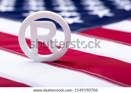 White Registered Trademark Sign On American Flag