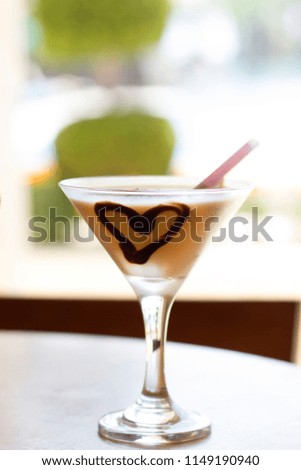 Cocktail with a chocolate heart and pink straw