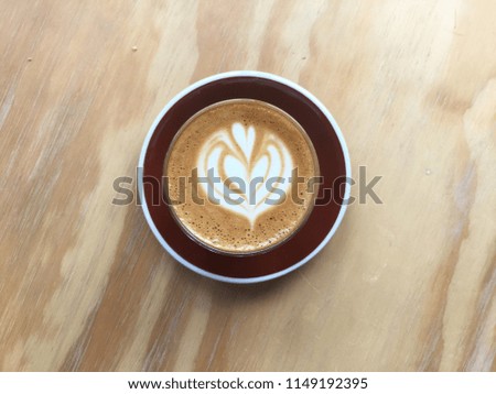 latte art coffee heart in hearts, on wooden background