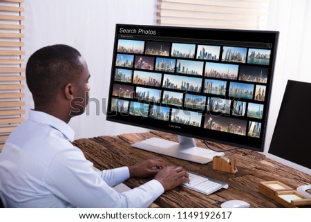 Close-up Of A Male Photo Editor Editing Images On Computer At Workplace