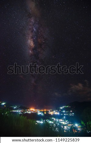 Beautiful milky way over the skies with a view of a city at night