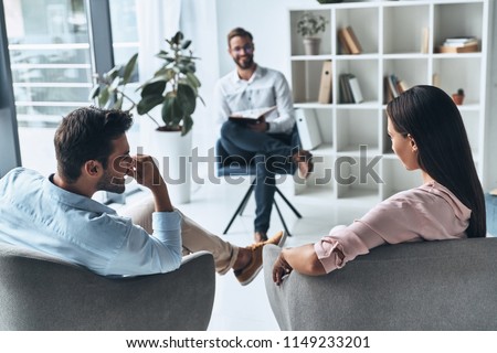 I can see a progress here! Young married couple talking while sitting on the therapy session with psychologist Royalty-Free Stock Photo #1149233201
