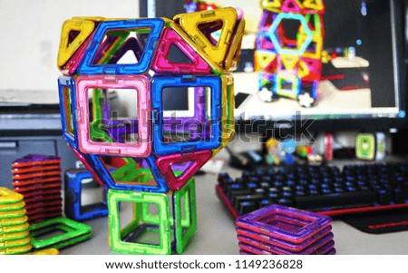 Bright geometric shapes on a magnetic base. Of these figures, the designer can assemble the various models. Perfect for the development of the child.