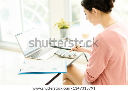 happy young woman working on laptop in workplace.entrepreneur working at start up.Business woman in office start-up working on laptop.