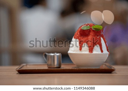 Korean shaved ice dessert with sweet toppings, Strawberry Bingsoo or Bingsu with soft focus, using as a background or wallpaper