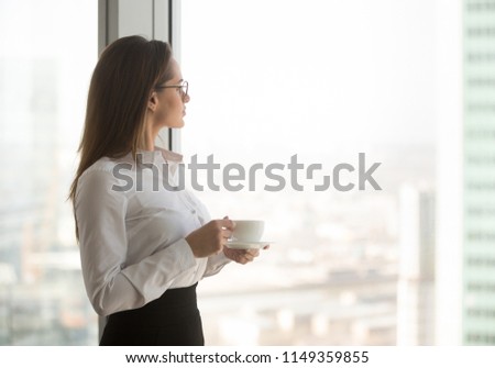 Thoughtful businesswoman drinking morning coffee 
