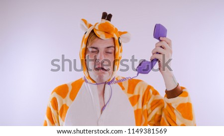 guy in a bright children's pajamas in the form of a kangaroo. emotional portrait of a student. costume presentation of children's animator.
