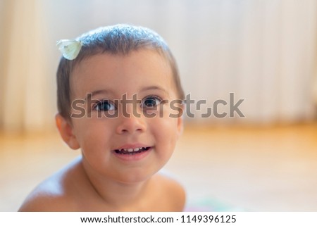 white butterfly on the head of a baby. Happy little boy with a butterfly on his head