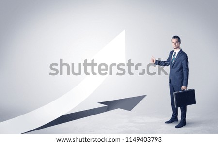 Young businessman hitchhiking with progressive arrow concept and copyspace