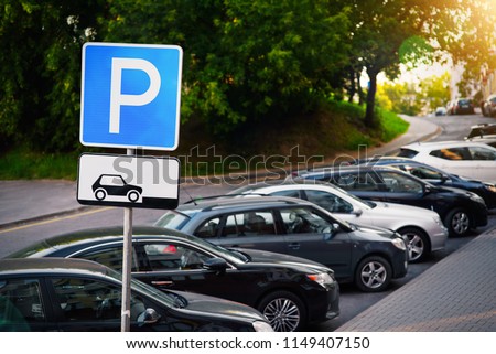 Parking sign. Vehicles take up way too much space in cities. Metropolis parking problems. Crowded parking.  Cars became biggest problem for urban ecology due emission and environmental pollution.
