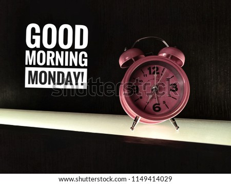 Motivation quotes concept image a pink clock and word - GOOD MORNING MONDAY! with black/dark vintage/ selective focus.
