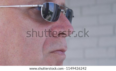 Confident Bodyguard Image Wearing Black Sunglasses Doing a Security Job